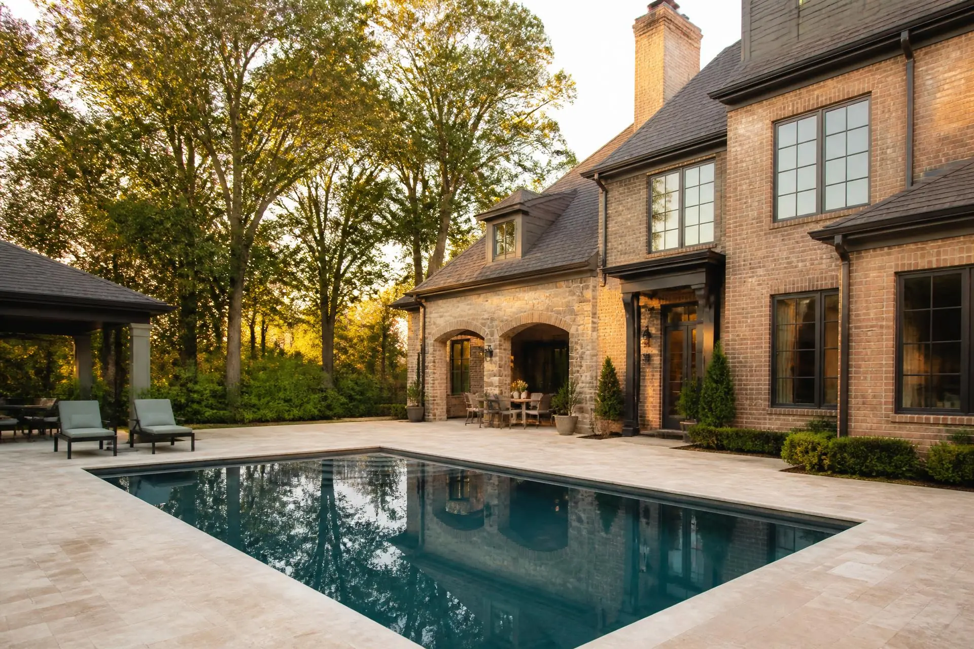 Rectangular gunite swimming pool at golden hour beside a North Mississippi home