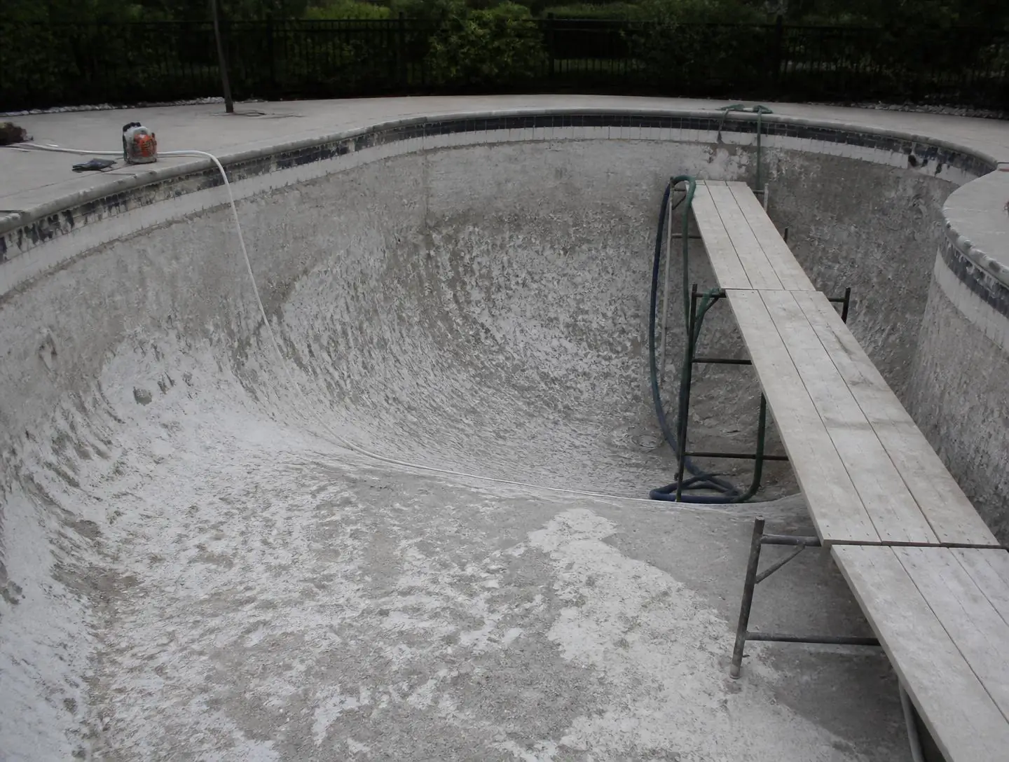 Drained pool being resurfaced during a renovation